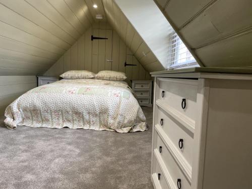 a bedroom with a bed in a attic at The Greig 1B in Wadhurst