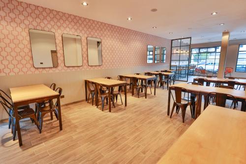 a dining room with wooden tables and chairs at Tierra Gaucha Hotel Boutique in San Carlos de Bariloche