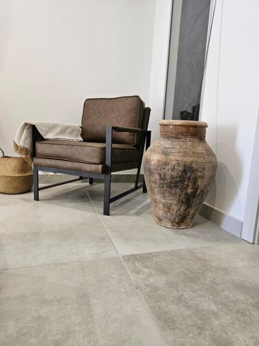 a chair and a vase in a room at Antico Borgo dei Templi in Agrigento