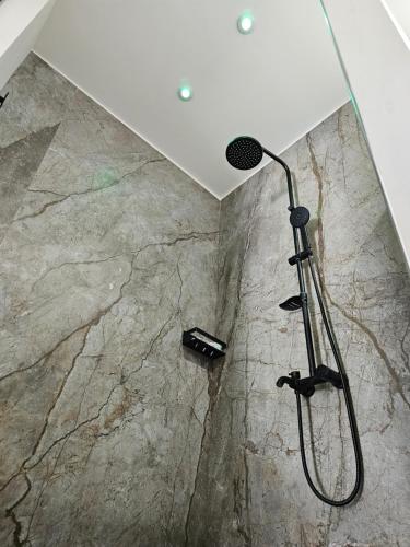 a shower in a bathroom with a stone floor at Antico Borgo dei Templi in Agrigento