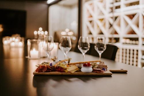 a table with a plate of food and wine glasses at Malangen Resort in Mestervik