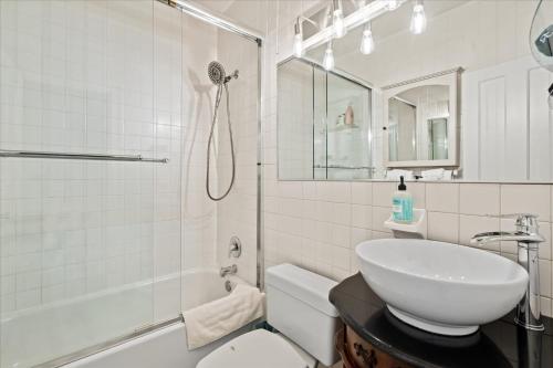 a white bathroom with a sink and a toilet at The W House Traveler's Dream Heart of Old Town in Alexandria