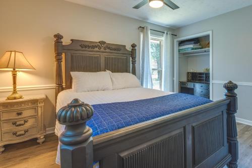 a bedroom with a large bed with a blue comforter at Pet-Friendly Rex Vacation Rental 18 Mi to Atlanta in Rex