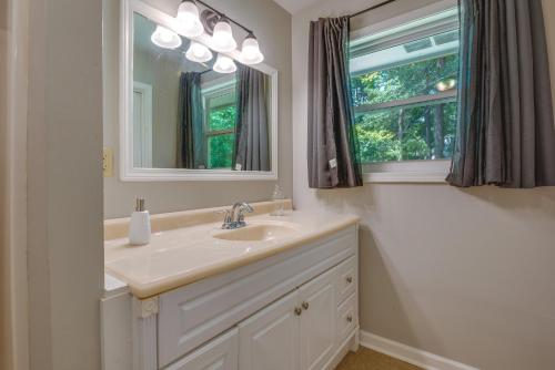 a bathroom with a sink and a mirror and a window at Pet-Friendly Rex Vacation Rental 18 Mi to Atlanta in Rex