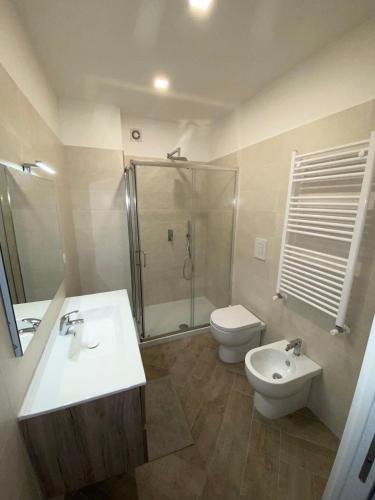 a bathroom with a sink and a toilet and a shower at Casa Daniela in Naples