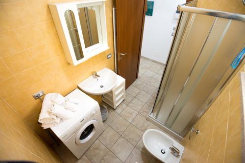 a bathroom with a sink and a toilet and a shower at Residenza Alpaluba in Vasto