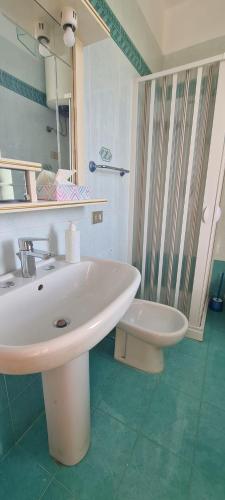 a bathroom with a sink and a shower and a toilet at I Sollazzi in Palermo