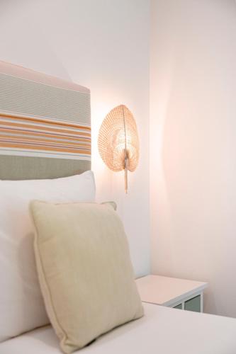 a white bed with a pillow and a lamp at Quinta Das Essências in Penafiel