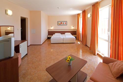 a living room with a couch and a table at Sunny Flower Family Hotel in Sunny Beach