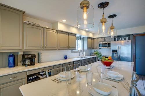 a kitchen with a table with plates and glasses on it at Lakefront Syracuse Home with Deck and Private Dock! in Syracuse