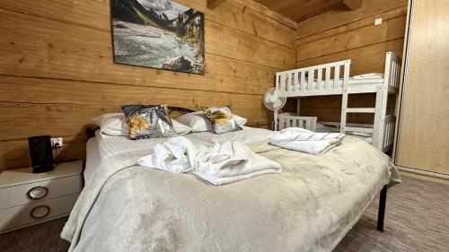 a bedroom with a bed with towels on it at Apartament Władek in Biały Dunajec