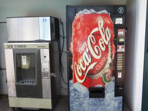 a cocacola vending machine with a can of coke at Americas Best Value Inn Loma Lodge in San Diego