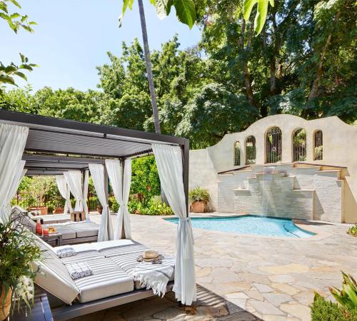 a patio with beds and a swimming pool at Kenwood Inn & Spa in Kenwood