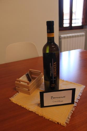a bottle of wine sitting on a napkin on a table at Casa Di Borgo in Todi