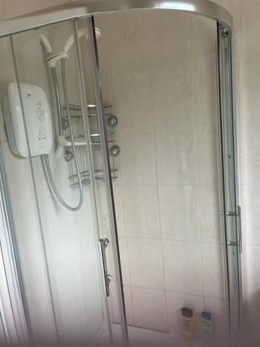 a shower with a glass door in a bathroom at Elegant Suites in Tuam in Tuam