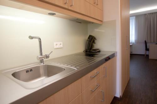 a kitchen with a sink and a counter top at Apart2stay in Luxembourg