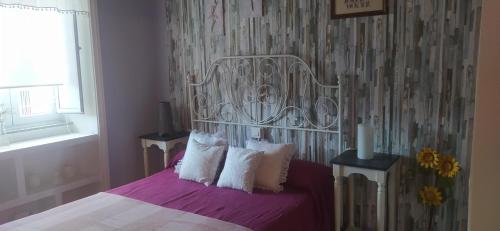 a bedroom with a bed with purple sheets and white pillows at Villa ELSA 27286AAXS8 TU986D RITGA-E-2023-05277 in Foz