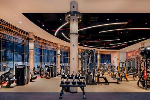 a gym with lots of equipment in a building at Sheraton Abu Dhabi Hotel & Resort in Abu Dhabi