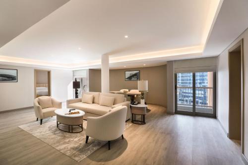 a living room with a couch and a table at Sheraton Abu Dhabi Hotel & Resort in Abu Dhabi
