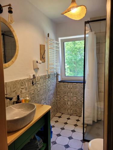 a bathroom with a sink and a window at Folwark Wierzchy in Wierzchy