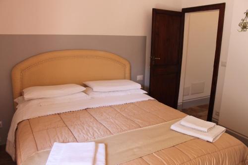 a bedroom with a bed with two towels on it at Casa Di Borgo in Todi