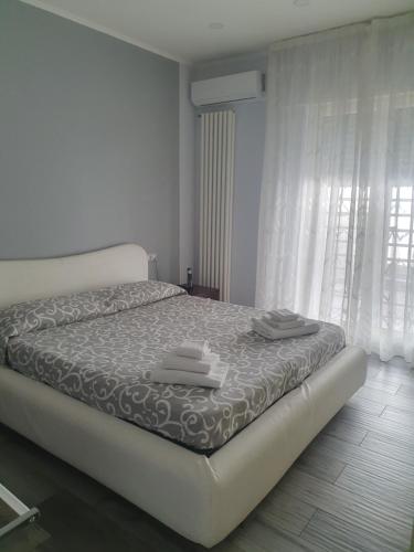a bedroom with a bed with towels on it at Villa Giulia in Pozzuoli
