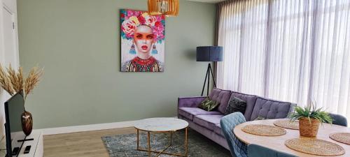 a living room with a purple couch and a table at Eindhoven City Apartments G 4P Free public parking in Eindhoven