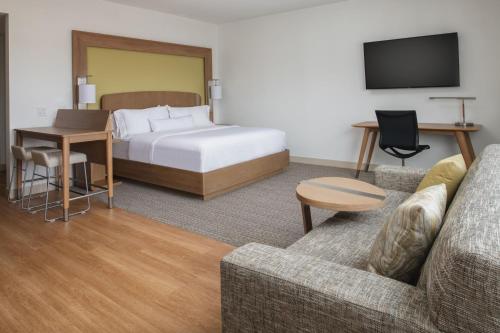 a hotel room with a bed and a couch at Element San Jose Milpitas in Milpitas