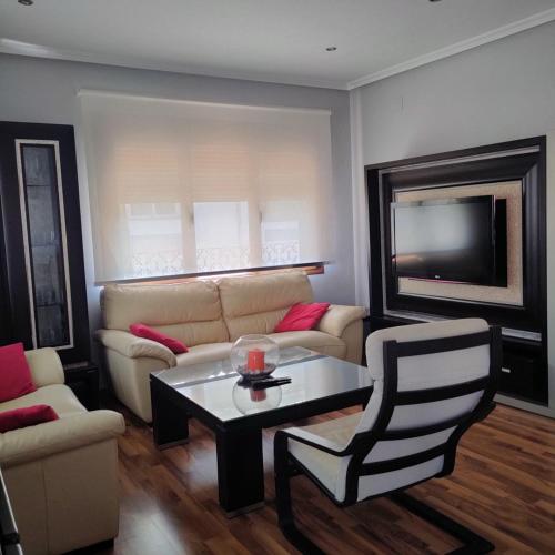 a living room with a couch and a table at vivienda rural AZALEA in Cortijos Nuevos