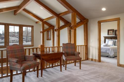 a room with a table and two chairs and a bed at The Porches in Steamboat Springs