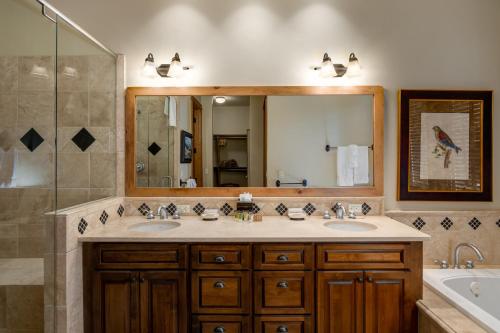 a bathroom with two sinks and a large mirror at The Porches in Steamboat Springs