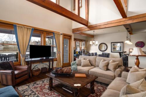 a living room with a couch and a table at The Porches in Steamboat Springs