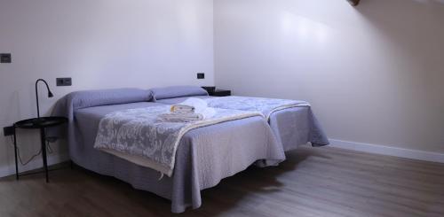 a bedroom with a bed with a blanket on it at La Casa de Loli in Luarca