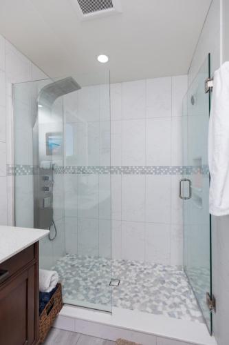 a bathroom with a shower with a glass door at New Floating Luxury: Unique Houseboat Retreat in Fleming Island