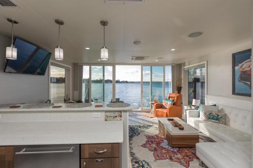 a kitchen and living room with a view of the water at New Floating Luxury: Unique Houseboat Retreat in Fleming Island