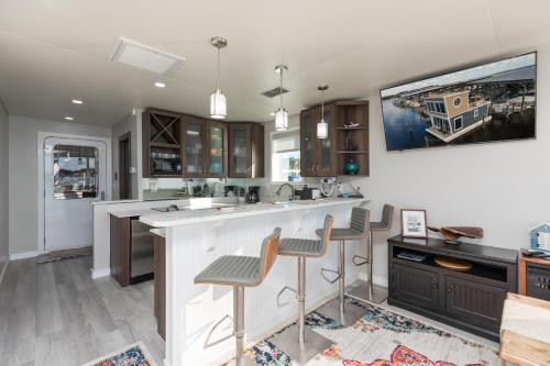 a kitchen with a large white island with bar stools at New Floating Luxury: Unique Houseboat Retreat in Fleming Island