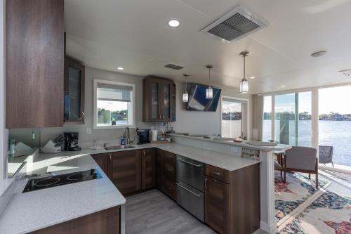 a kitchen with wooden cabinets and a counter top at New Floating Luxury: Unique Houseboat Retreat in Fleming Island