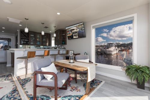 a kitchen with a table and chairs and a window at New Floating Luxury: Unique Houseboat Retreat in Fleming Island