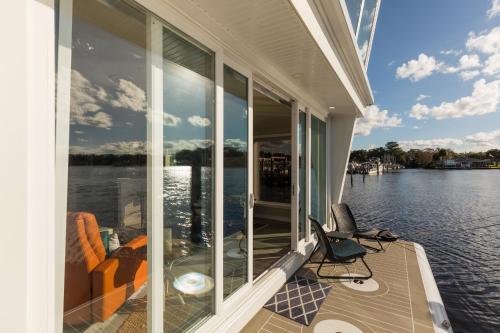 a screened in porch with a view of the water at New Floating Luxury: Unique Houseboat Retreat in Fleming Island