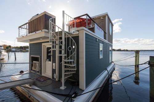 a house on a boat in the water at New Floating Luxury: Unique Houseboat Retreat in Fleming Island