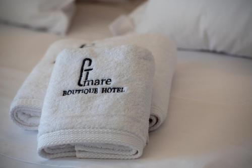 a towel sitting on top of a bed at G Mare Boutique Hotel in Neos Marmaras