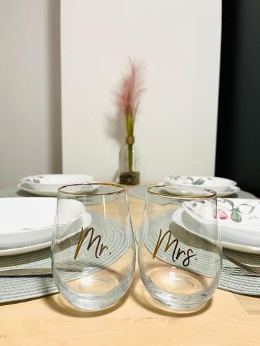 two glasses with the words m and me on them on a table at Apartment MILA in Sankt Peter