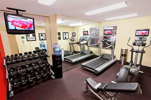 a gym with several tread machines and a flat screen tv at TownePlace Suites by Marriott Sunnyvale Silicon Valley in Sunnyvale