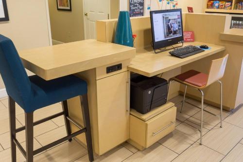 a desk with a computer monitor and a chair at TownePlace Suites by Marriott Sunnyvale Silicon Valley in Sunnyvale