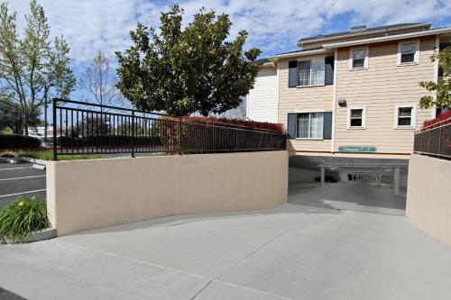 a house with a fence and a sidewalk at TownePlace Suites by Marriott Sunnyvale Silicon Valley in Sunnyvale