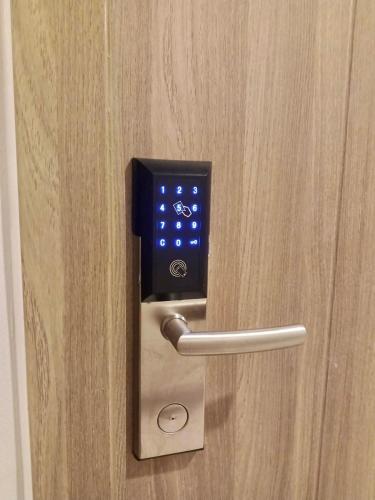 a close up of a door with a lock at S Residences Condo PoolView Balcony in SM MOA near NAIA in Manila