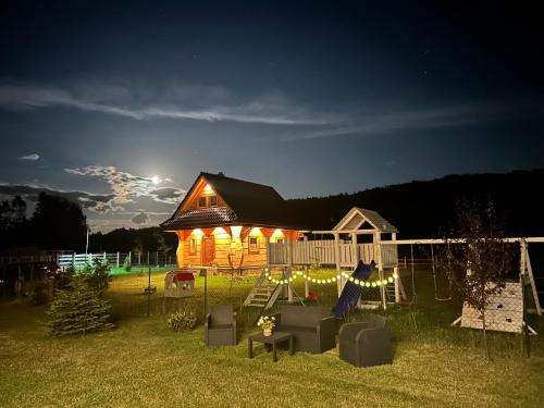 a house lit up at night with lights on it at Słoneczna Chata z Bali in Lądek-Zdrój