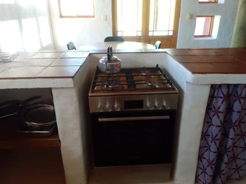 a stove in a kitchen with a counter top at AGAVE HOUSE in Prince Albert