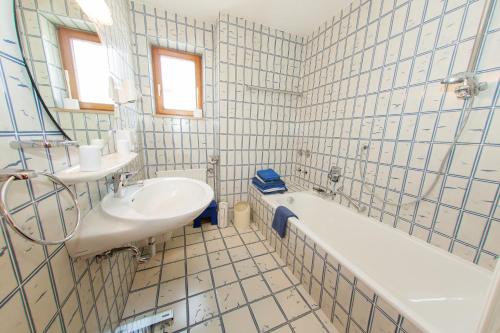 La salle de bains est pourvue d'un lavabo, d'une baignoire et de toilettes. dans l'établissement Frühlingshof, à Reit im Winkl