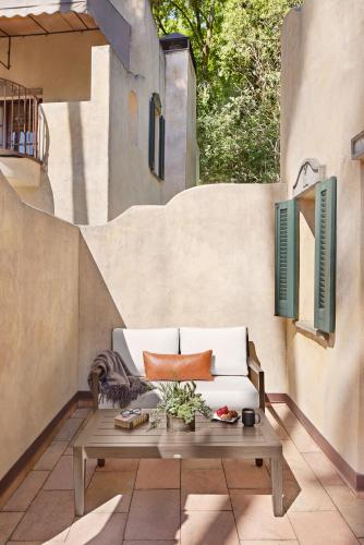 a patio with a white couch and a table at Kenwood Inn & Spa in Kenwood